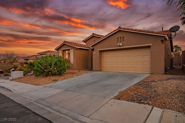 10513 Shanna Trellis Ave, Las Vegas, NV 89144 - mediterranean / spanish home featuring stucco siding, driveway, a tiled roof, and a garage