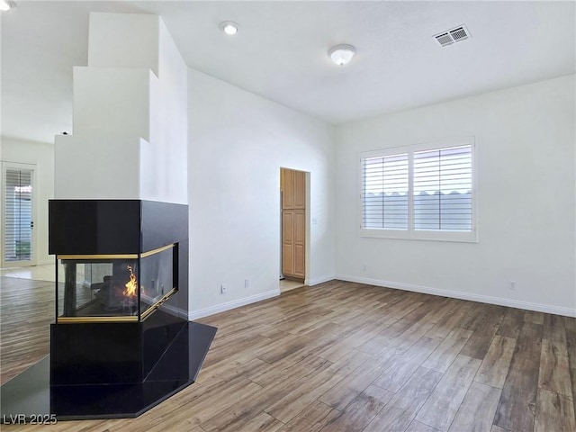 8981 Rivers Edge Dr, Las Vegas, NV 89117 - unfurnished living room with healthy amount of natural light and wood finished floors