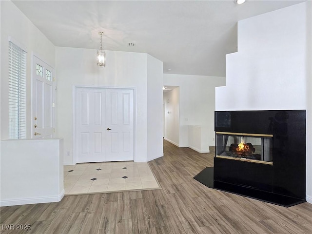 8981 Rivers Edge Dr, Las Vegas, NV 89117 - entryway with wood finished floors and a multi sided fireplace
