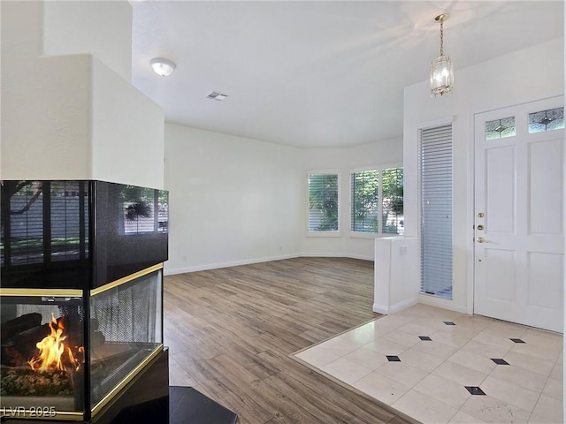 8981 Rivers Edge Dr, Las Vegas, NV 89117 - foyer entrance featuring wood finished floors and a multi sided fireplace