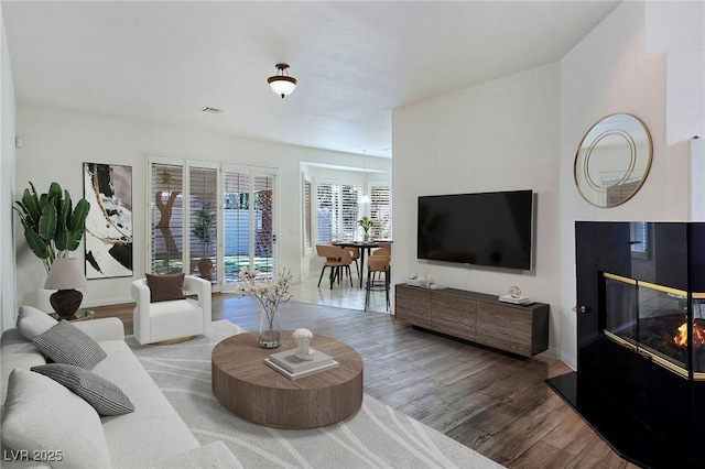 8981 Rivers Edge Dr, Las Vegas, NV 89117 - living area with wood finished floors and a multi sided fireplace