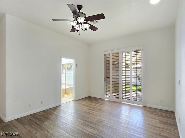 8981 Rivers Edge Dr, Las Vegas, NV 89117 - unfurnished room with plenty of natural light, wood finished floors, and a ceiling fan