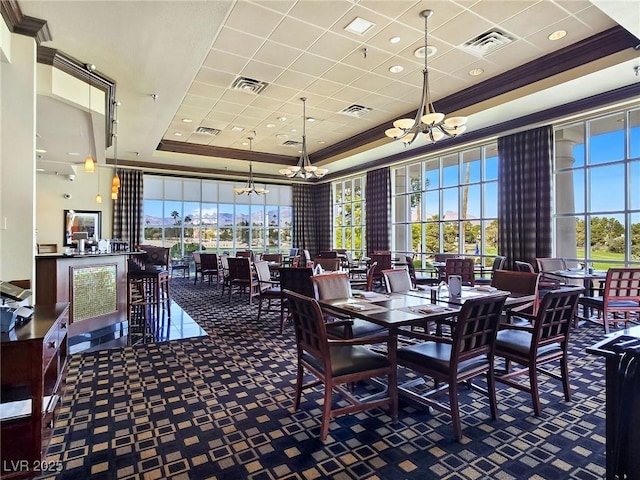 8981 Rivers Edge Dr, Las Vegas, NV 89117 - carpeted dining room featuring a raised ceiling, a chandelier, ornamental molding, and a high ceiling
