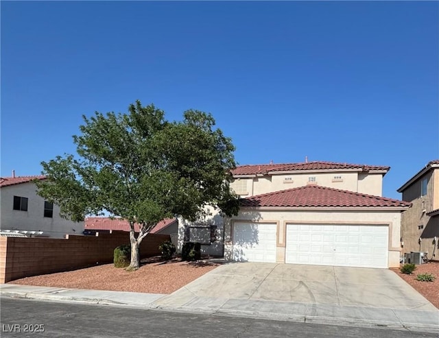 4126 Jessica Marie St, North Las Vegas, NV 89032 - mediterranean / spanish home featuring an attached garage, concrete driveway, a tile roof, and stucco siding