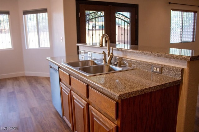 4126 Jessica Marie St, North Las Vegas, NV 89032 - kitchen with an island with sink, wood finished floors, healthy amount of natural light, and dishwasher