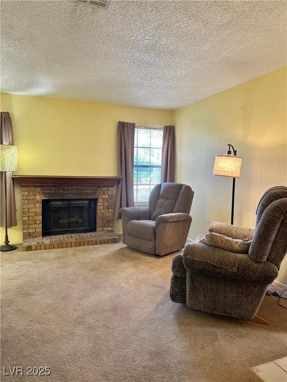 5576 W Rochelle Ave Unit 27A, Las Vegas, NV 89103 - living room featuring carpet flooring, a textured ceiling, and a fireplace
