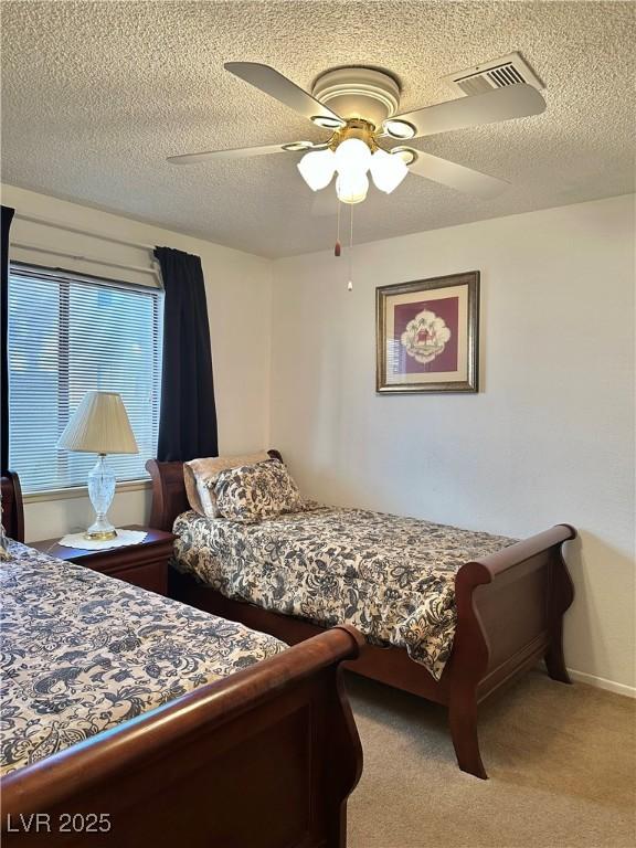 5576 W Rochelle Ave Unit 27A, Las Vegas, NV 89103 - bedroom with a textured ceiling, a ceiling fan, and carpet floors