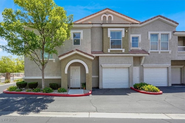 9975 Peace Way Unit 2009, Las Vegas, NV 89147 - multi unit property with stucco siding, a garage, and driveway