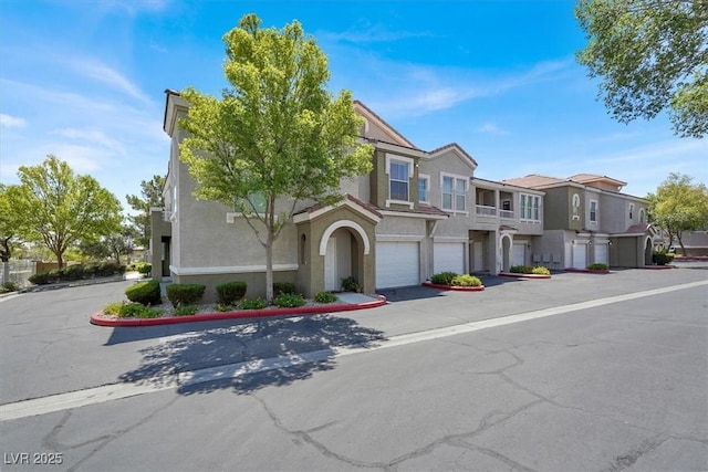 9975 Peace Way Unit 2009, Las Vegas, NV 89147 - townhome / multi-family property with a residential view, stucco siding, and a garage