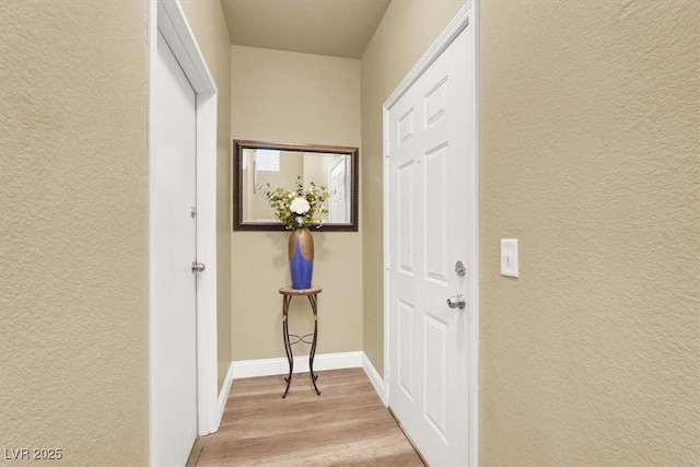 9975 Peace Way Unit 2009, Las Vegas, NV 89147 - hallway with light wood-style flooring and a textured wall