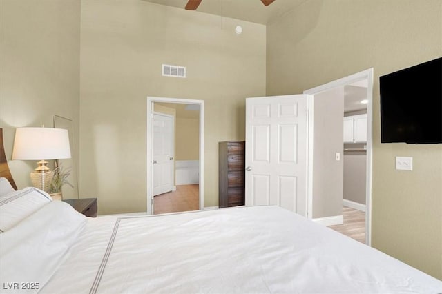 9975 Peace Way Unit 2009, Las Vegas, NV 89147 - bedroom with a high ceiling, ceiling fan, and connected bathroom
