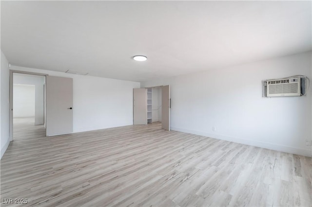 1808 E Saint Louis Ave, Las Vegas, NV 89104 - unfurnished room with light wood-style floors and a wall unit AC