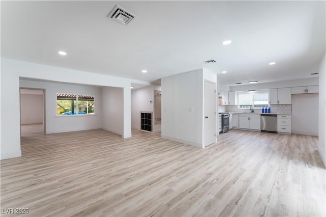 1808 E Saint Louis Ave, Las Vegas, NV 89104 - unfurnished living room featuring healthy amount of natural light, light wood-style floors, and recessed lighting