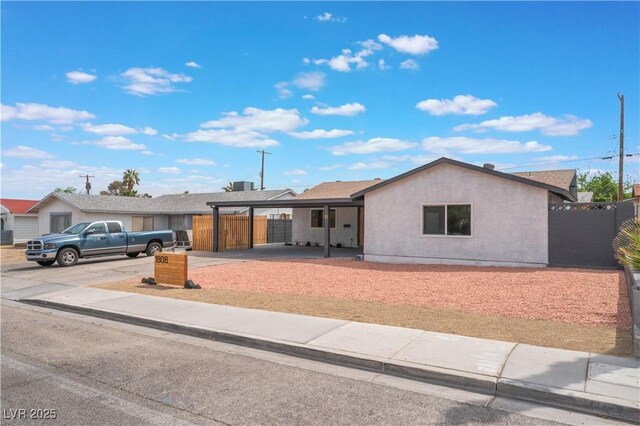 1808 E Saint Louis Ave, Las Vegas, NV 89104 - ranch-style home with stucco siding, an attached carport, and driveway