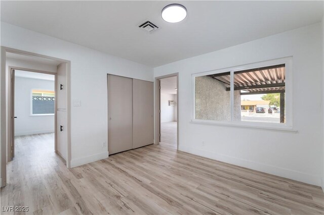 1808 E Saint Louis Ave, Las Vegas, NV 89104 - unfurnished bedroom with light wood finished floors and a closet