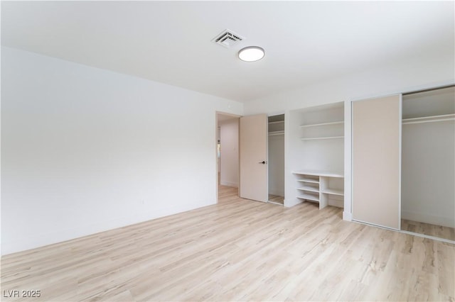 1808 E Saint Louis Ave, Las Vegas, NV 89104 - unfurnished bedroom with multiple closets and light wood-type flooring