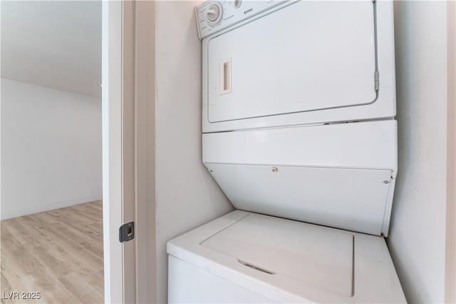 1808 E Saint Louis Ave, Las Vegas, NV 89104 - washroom featuring stacked washer / dryer and wood finished floors