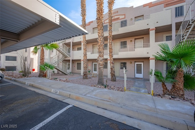 2068 Mesquite Ln Unit 203, Laughlin, NV 89029 - view of building exterior with stairway and uncovered parking