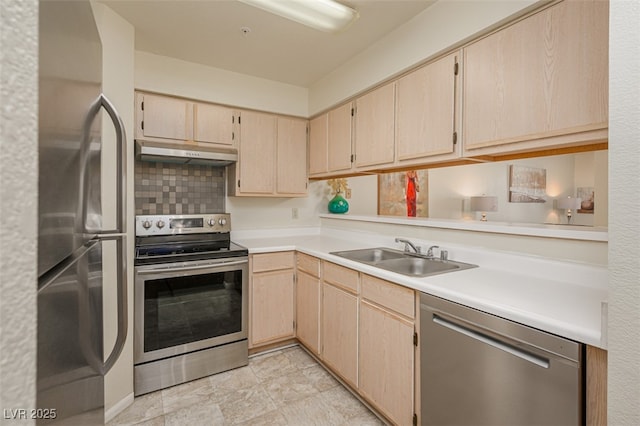 2068 Mesquite Ln Unit 203, Laughlin, NV 89029 - kitchen featuring stainless steel appliances, under cabinet range hood, light brown cabinets, light countertops, and decorative backsplash