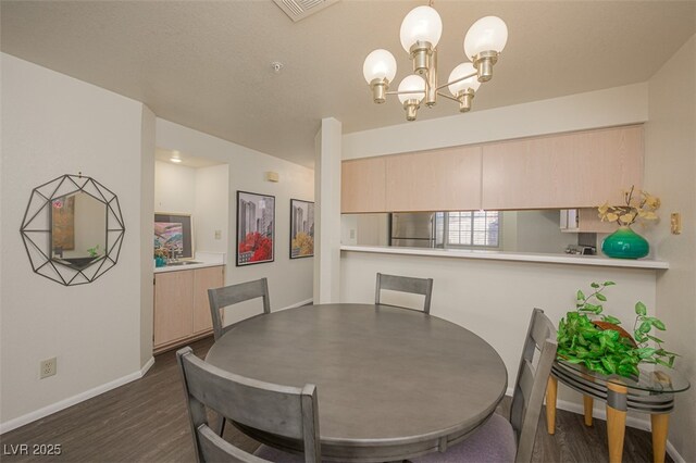 2068 Mesquite Ln Unit 203, Laughlin, NV 89029 - dining room with dark wood-style floors and a chandelier