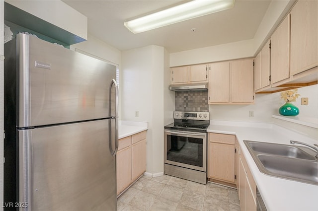 2068 Mesquite Ln Unit 203, Laughlin, NV 89029 - kitchen featuring appliances with stainless steel finishes, under cabinet range hood, light brown cabinetry, light countertops, and decorative backsplash