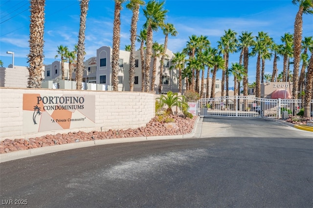 2068 Mesquite Ln Unit 203, Laughlin, NV 89029 - view of asphalt road with a gated entry, curbs, a residential view, and a gate