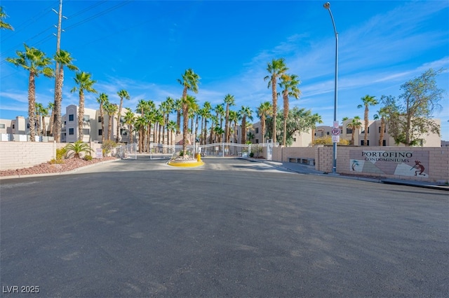 2068 Mesquite Ln Unit 203, Laughlin, NV 89029 - view of asphalt road with a residential view, a gate, sidewalks, and street lights