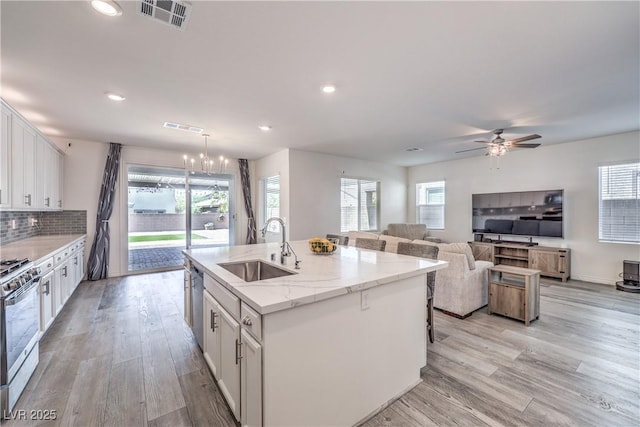 3821 Nesting Wren Dr, North Las Vegas, NV 89084 - kitchen featuring appliances with stainless steel finishes, white cabinets, light wood-style floors, a ceiling fan, and recessed lighting