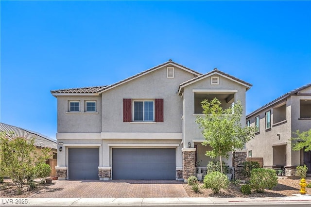 3821 Nesting Wren Dr, North Las Vegas, NV 89084 - view of front of home with a garage, stucco siding, stone siding, and decorative driveway