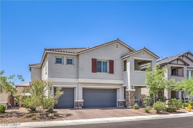 3821 Nesting Wren Dr, North Las Vegas, NV 89084 - view of front of property featuring stucco siding, a garage, a tiled roof, and stone siding
