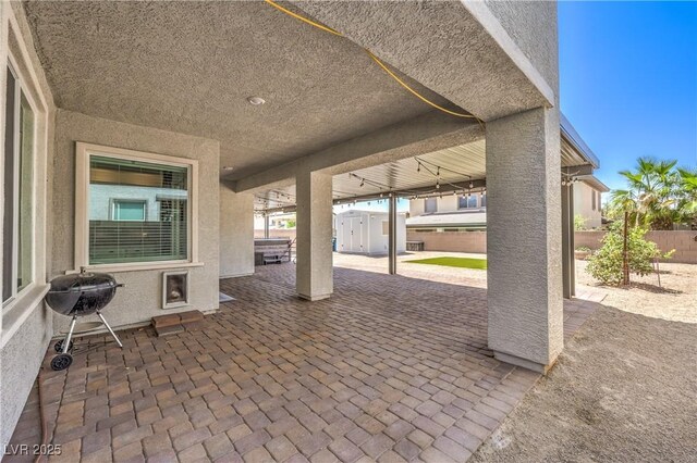 3821 Nesting Wren Dr, North Las Vegas, NV 89084 - fenced backyard with a patio area, a storage shed, and a grill