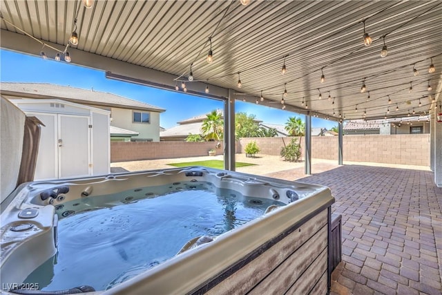 3821 Nesting Wren Dr, North Las Vegas, NV 89084 - fenced backyard with a storage unit, a hot tub, and a patio