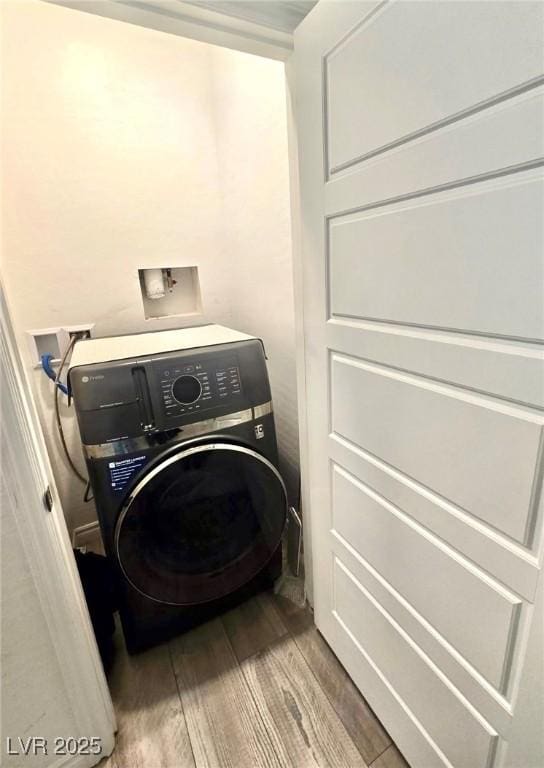 3821 Nesting Wren Dr, North Las Vegas, NV 89084 - washroom with washer / clothes dryer and wood finished floors