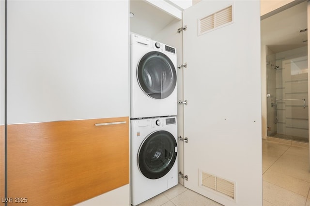 3726 Las Vegas Blvd Unit 704, Las Vegas, NV 89158 - laundry area with stacked washing machine and dryer and light tile patterned flooring