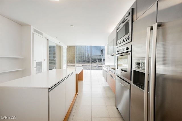 3726 Las Vegas Blvd Unit 704, Las Vegas, NV 89158 - kitchen featuring appliances with stainless steel finishes, light countertops, modern cabinets, light tile patterned flooring, and floor to ceiling windows