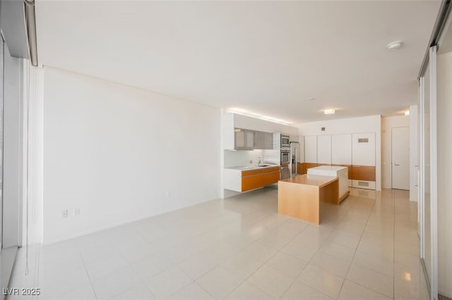 3726 Las Vegas Blvd Unit 704, Las Vegas, NV 89158 - kitchen featuring a kitchen island, light countertops, modern cabinets, and stainless steel oven