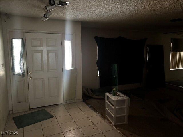 4928 E Philadelphia Ave, Las Vegas, NV 89104 - entryway featuring a textured ceiling and light tile patterned floors