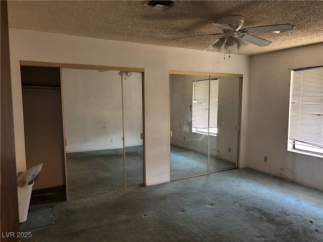 4928 E Philadelphia Ave, Las Vegas, NV 89104 - unfurnished bedroom with multiple closets, carpet flooring, and a textured ceiling