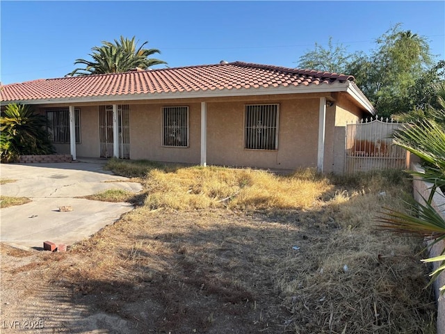 4928 E Philadelphia Ave, Las Vegas, NV 89104 - view of front facade with stucco siding and a tiled roof