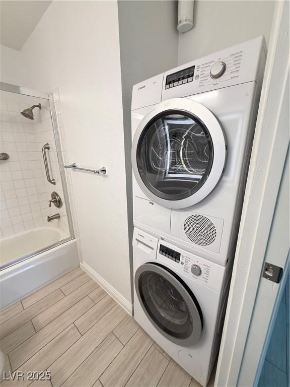 3606 Di Salvo Dr Unit 133, Las Vegas, NV 89103 - washroom featuring stacked washing machine and dryer and wood tiled floors