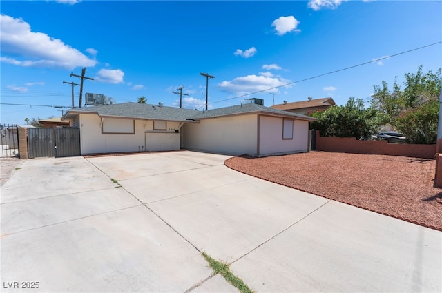 704 N Wallace Dr, Las Vegas, NV 89107 - view of front of home featuring driveway, a gate, and a patio