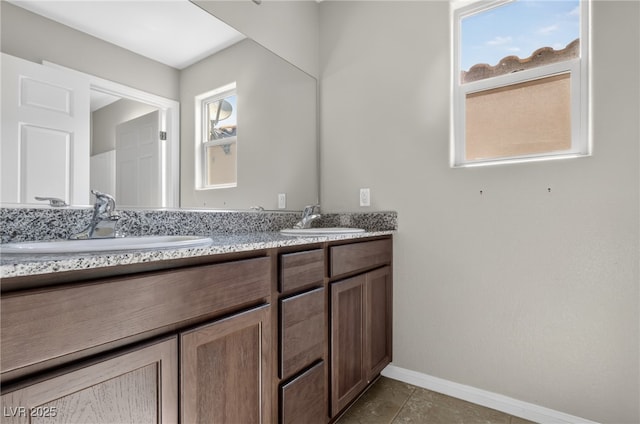2175 Limestone Cove Ct, Laughlin, NV 89029 - bathroom with double vanity and baseboards