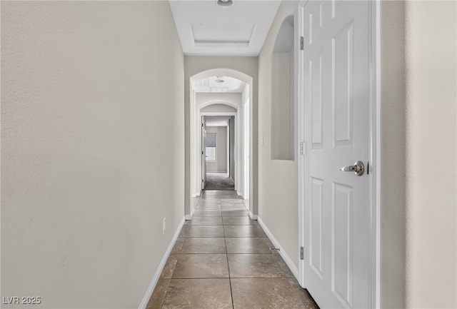 2175 Limestone Cove Ct, Laughlin, NV 89029 - hallway with arched walkways and dark tile patterned flooring