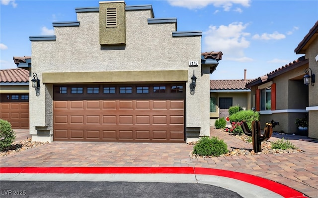 2175 Limestone Cove Ct, Laughlin, NV 89029 - view of front facade with stucco siding, a tiled roof, driveway, and an attached garage