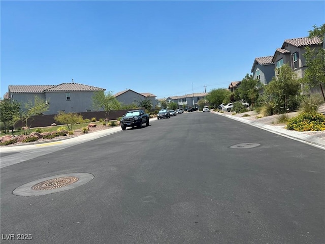 4056 Campeche Ave, Las Vegas, NV 89121 - view of asphalt road with a residential view, curbs, and sidewalks