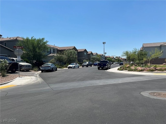 4056 Campeche Ave, Las Vegas, NV 89121 - view of asphalt road with a residential view, curbs, sidewalks, and traffic signs