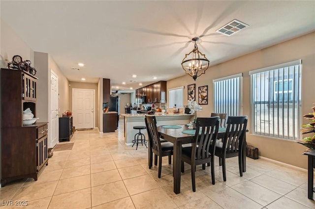 7224 Piute Mesa St, North Las Vegas, NV 89084 - dining area with a chandelier, light tile patterned floors, and recessed lighting