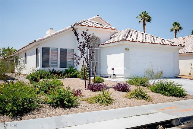 5233 Camino Del Rancho, Las Vegas, NV 89130 - mediterranean / spanish-style house featuring a garage, stucco siding, and a tiled roof