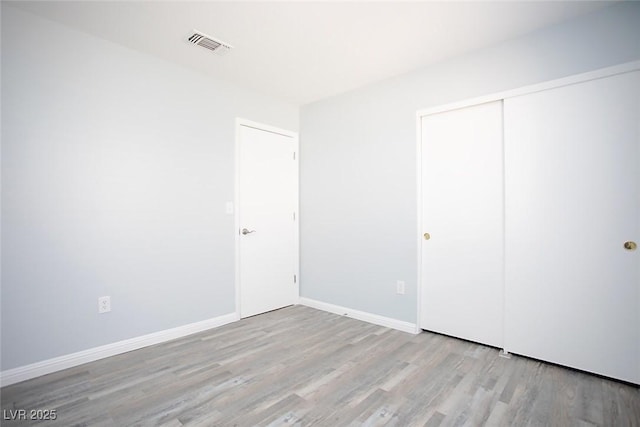 5233 Camino Del Rancho, Las Vegas, NV 89130 - unfurnished bedroom featuring wood finished floors and a closet