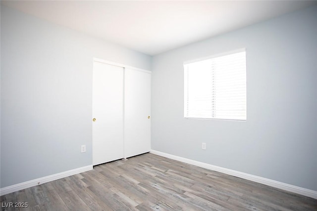 5233 Camino Del Rancho, Las Vegas, NV 89130 - unfurnished bedroom featuring wood finished floors and a closet